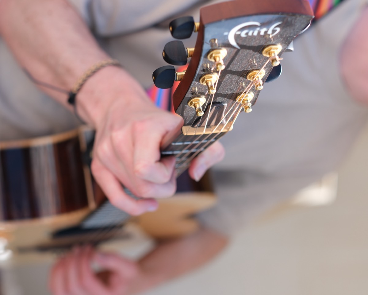 Close-up of Matthew's hand on the guitar fretboard