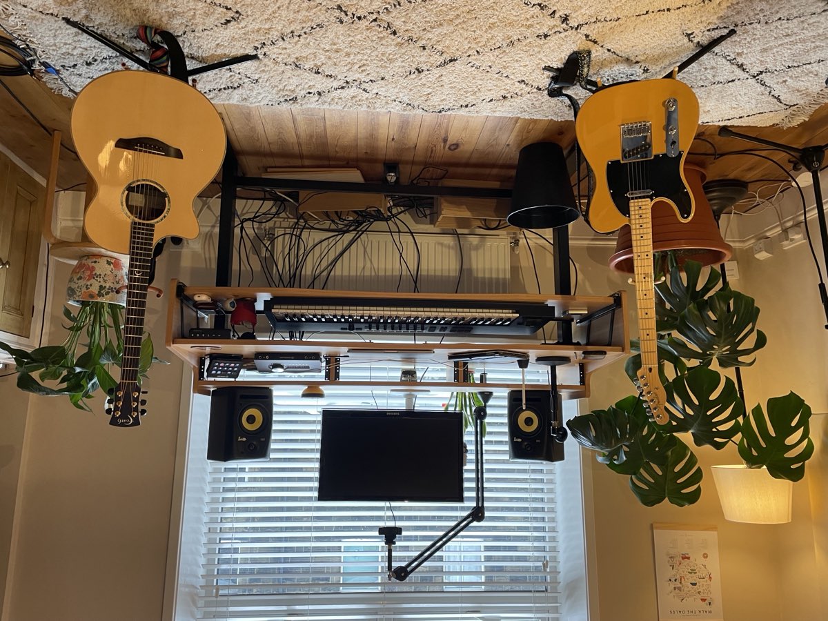Matthew's teaching room with guitars, desk and plants